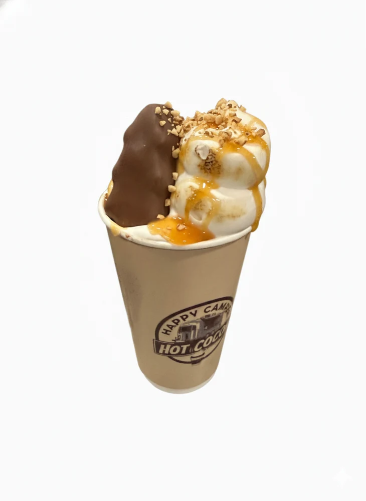 Peanut Butter Caramel S'more hot cocoa topped with a Reese's peanut butter tree, toasted marshmallow fluff, and caramel